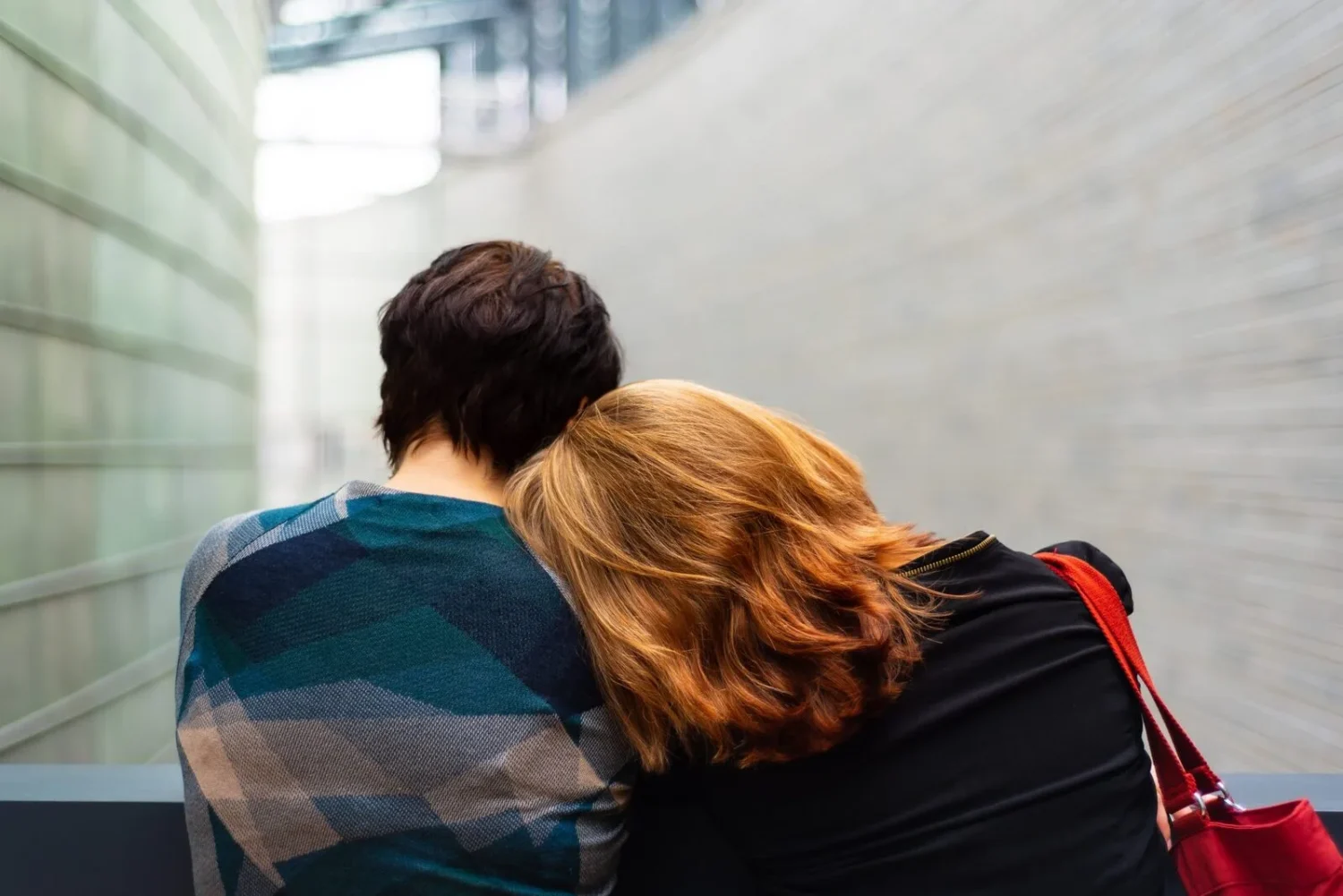 A couple leaning on each other.