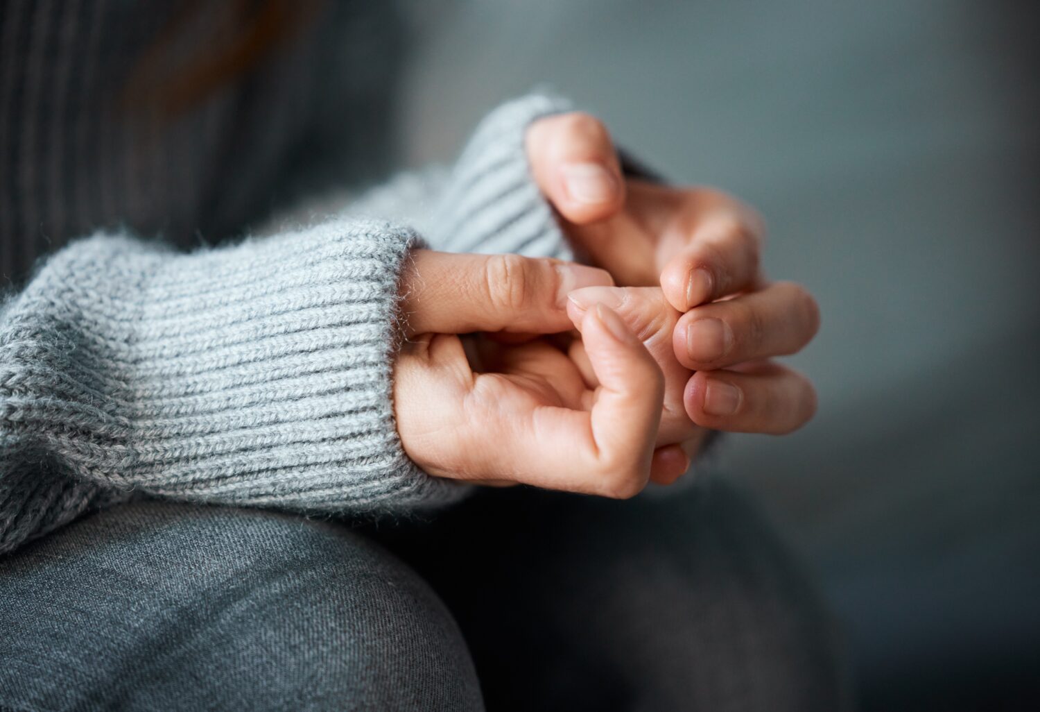 a women's hands anxiously fiddling