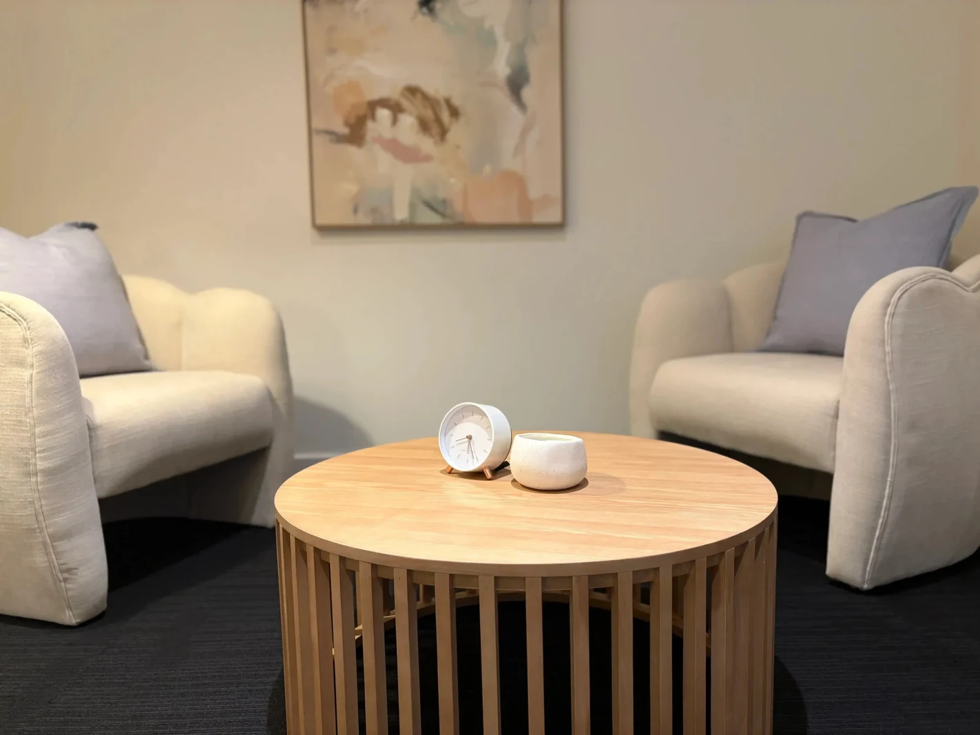 Two couches and a round wooden table.