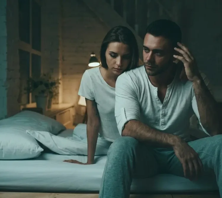 Woman appearing emotionally withdrawn while sitting beside her partner