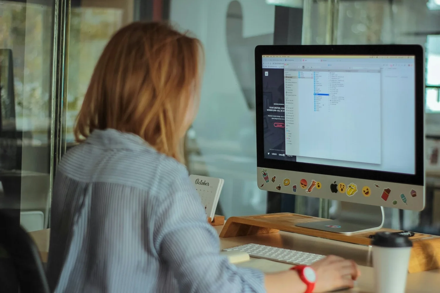 back of a women leaning forward on a computer