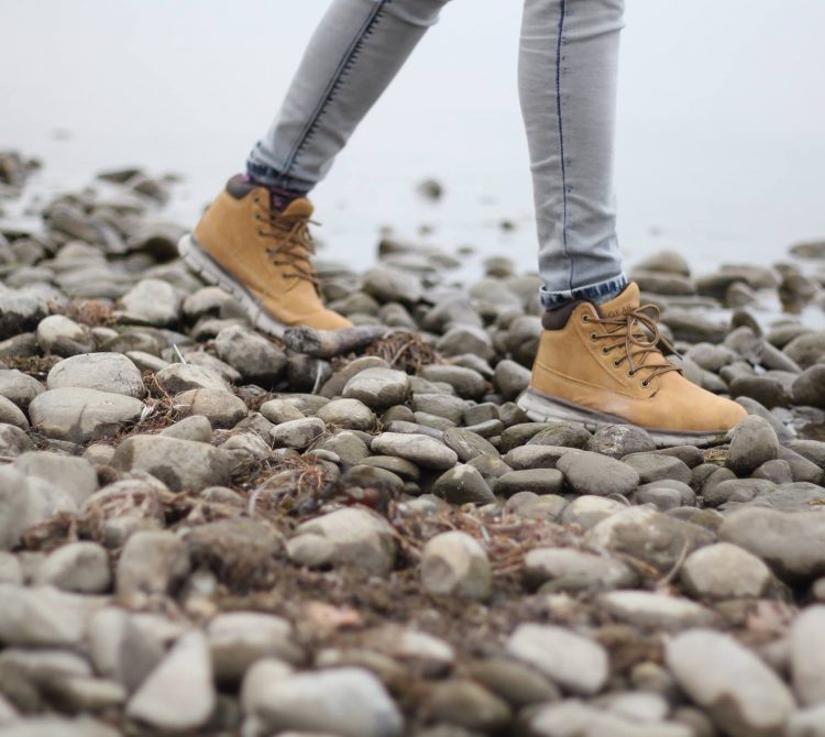 women's legs walking on rocks