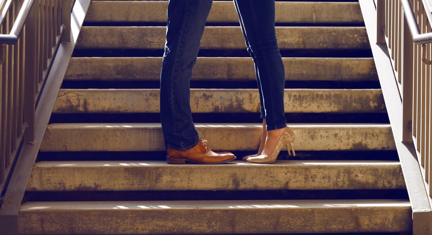 legs of couple hugging on the steps