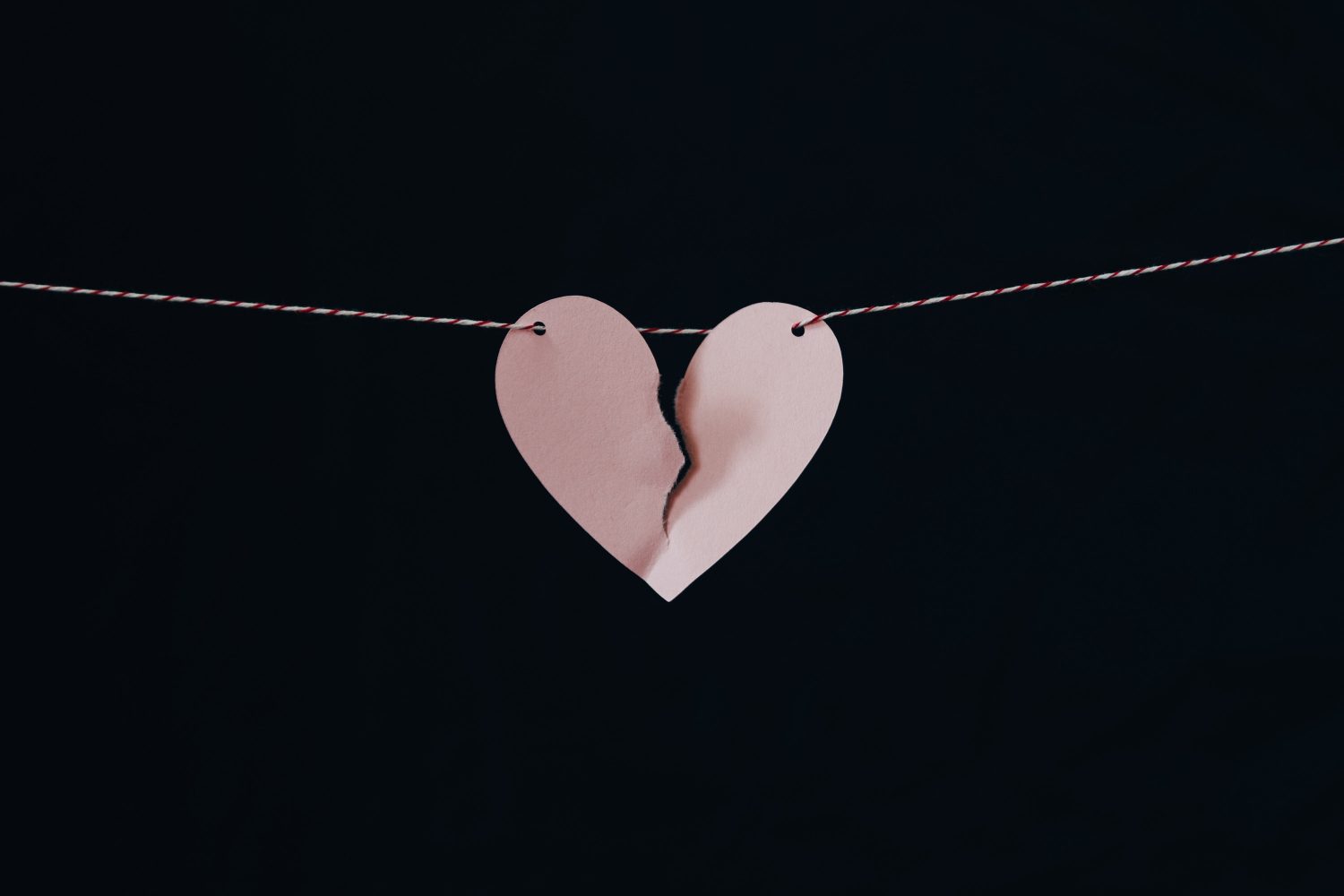 broken paper love heart on a string