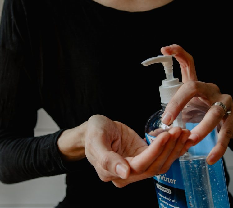 Lady using hand sanitiser on hands