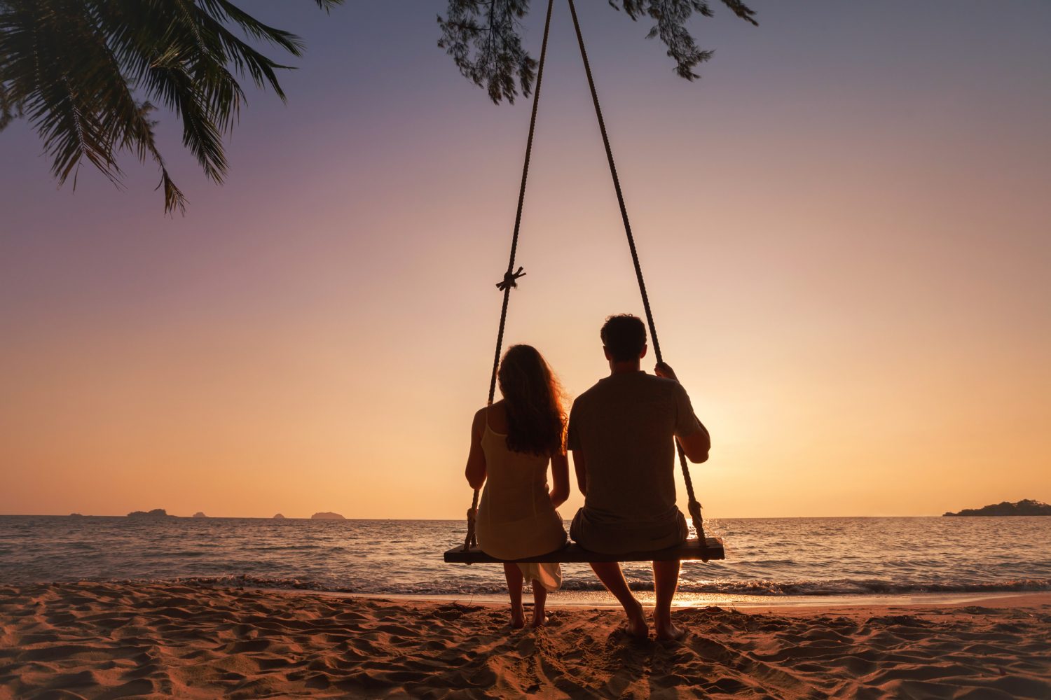 silhouette of romantic couple on sunset beach