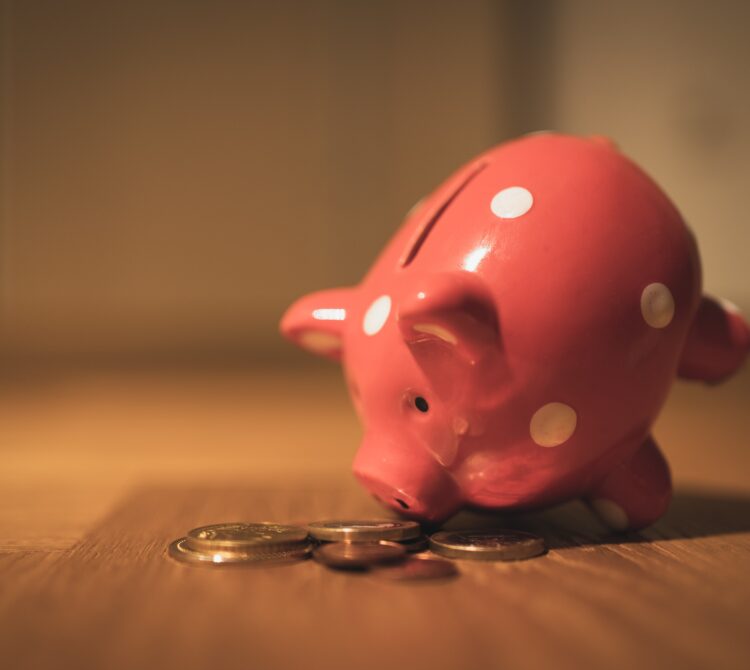 A piggy bank leaning over and counting money