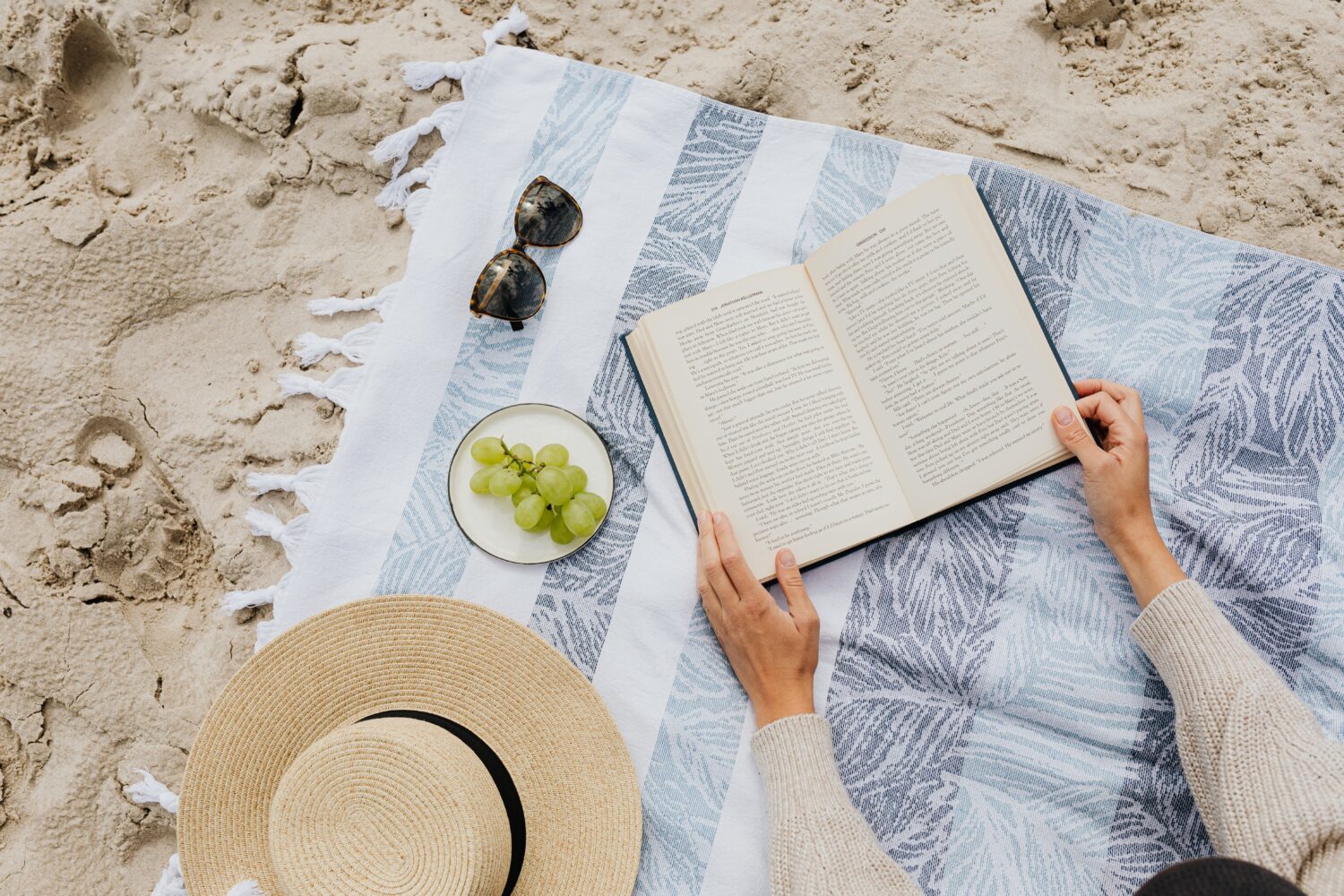 A book on a towel at the beach