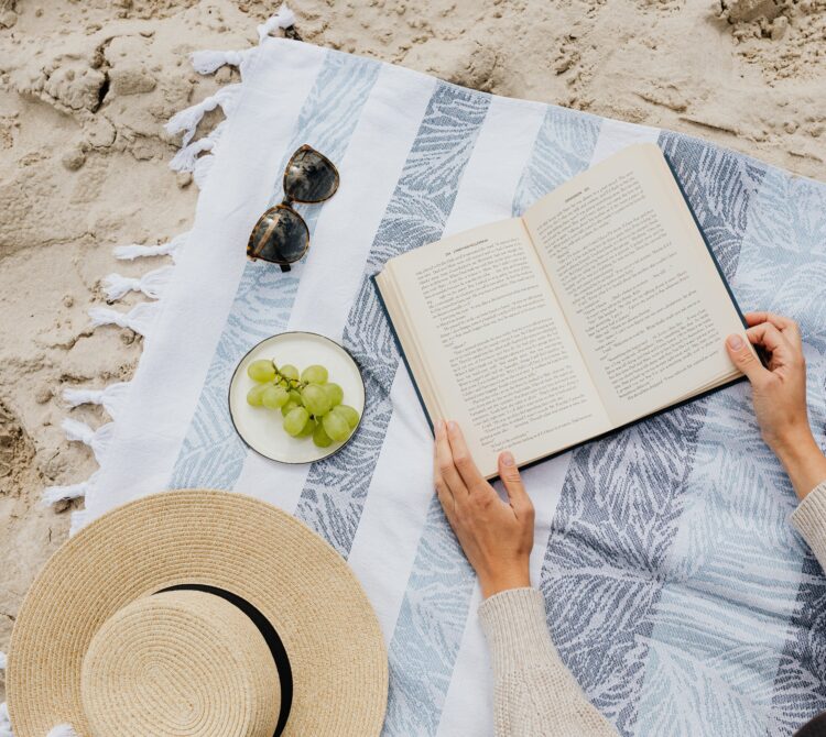 A book on a towel at the beach