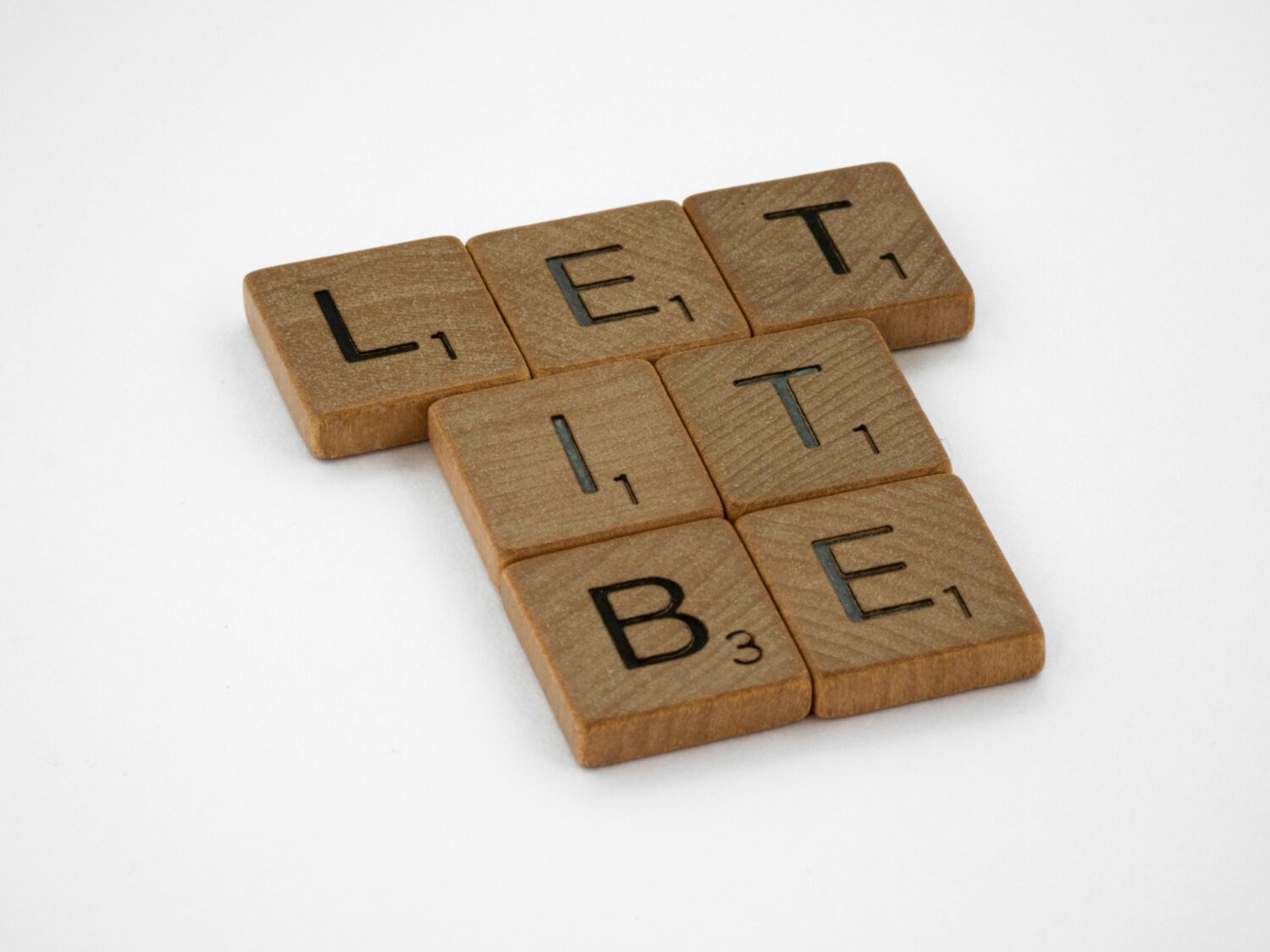 Scrabble letters spelling out "let it be"