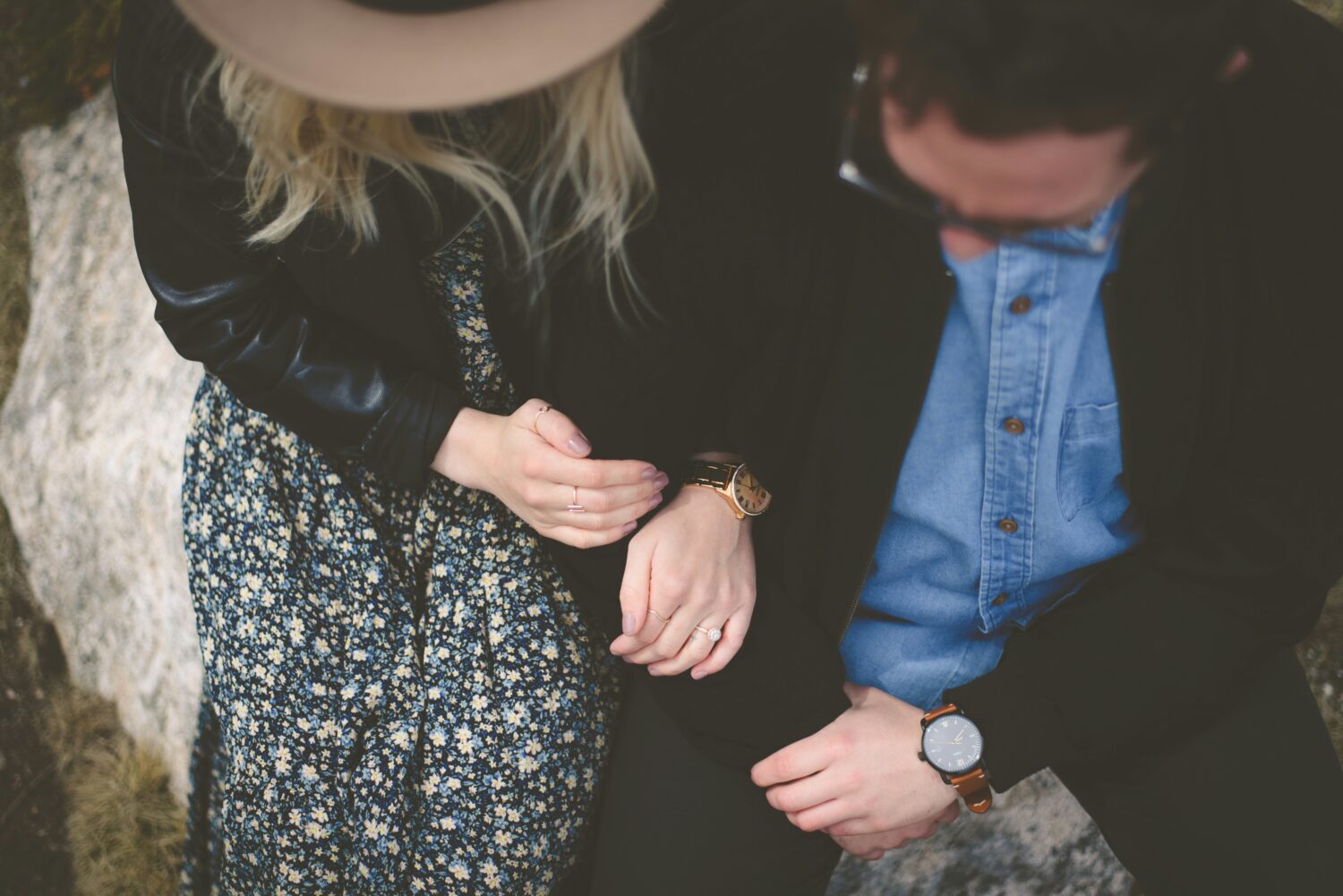 Birds eye view of two people holding hands