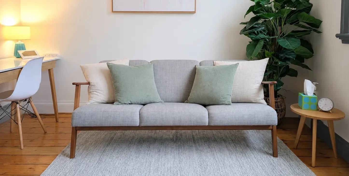 Psychologist therapy room at Hawthorn practice with long couch and green cushions