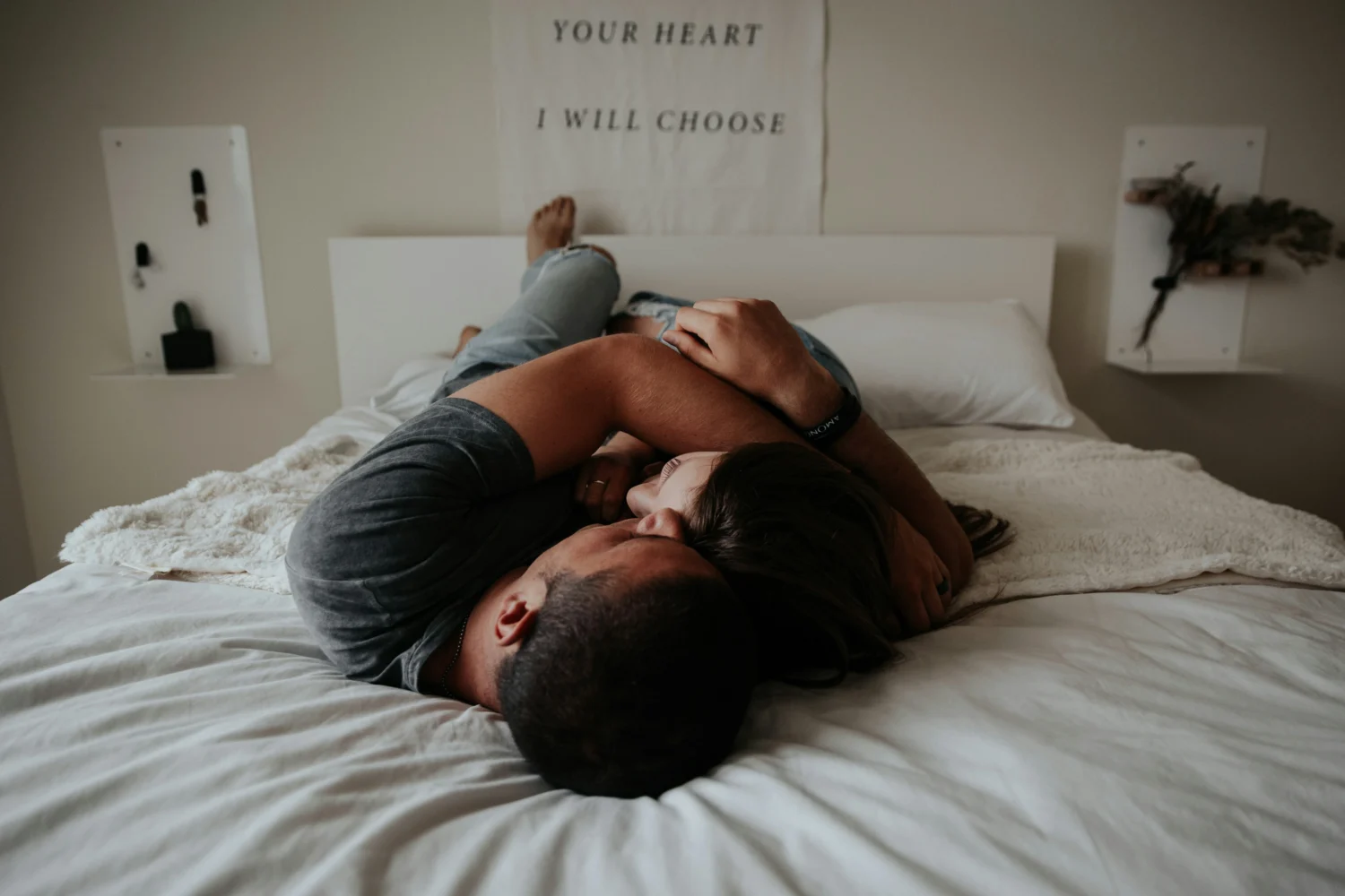 A couple cuddling on a bed
