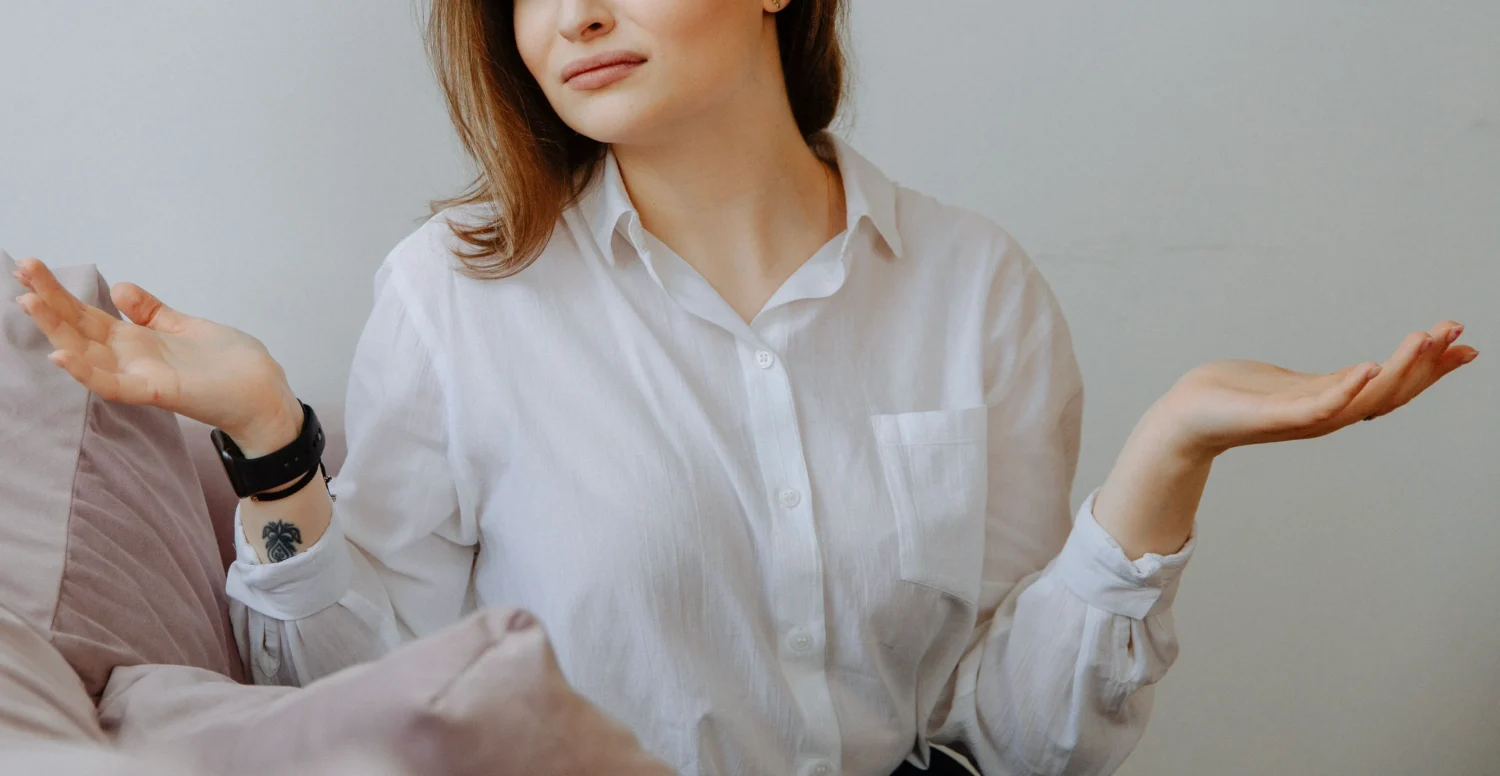 person holding two hands up and shrugging.